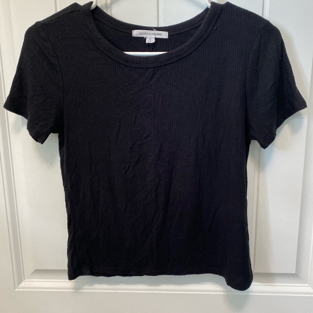 Caution to the Wind top. Size Large. Made of rayon and spandex.